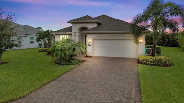 8369 Paladin Sq, Vero Beach, FL 32967 - single story home featuring stucco siding, a garage, decorative driveway, and a yard