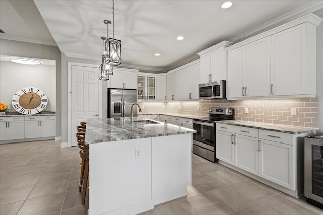 8369 Paladin Sq, Vero Beach, FL 32967 - kitchen with stainless steel appliances, a sink, crown molding, tasteful backsplash, and wine cooler