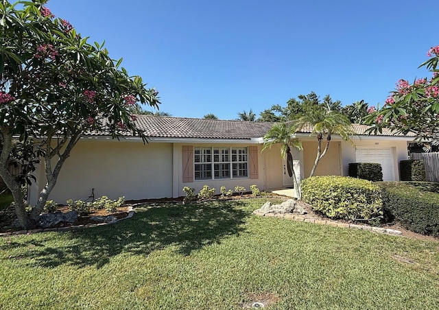 1807 Crafton Rd, North Palm Beach, FL 33408 - ranch-style house with an attached garage, stucco siding, a front yard, and a tile roof