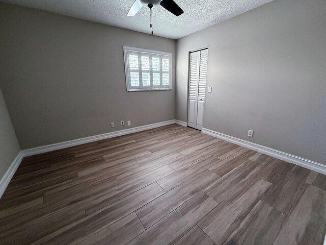 1807 Crafton Rd, North Palm Beach, FL 33408 - unfurnished room featuring ceiling fan, wood finished floors, a textured ceiling, and baseboards