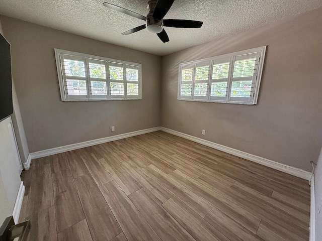1807 Crafton Rd, North Palm Beach, FL 33408 - spare room with wood finished floors, a ceiling fan, a textured ceiling, and baseboards
