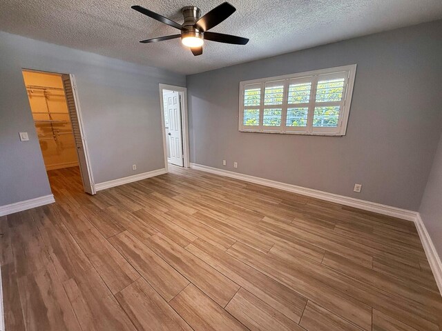 1807 Crafton Rd, North Palm Beach, FL 33408 - unfurnished room with light wood-style floors, a ceiling fan, baseboards, and a textured ceiling