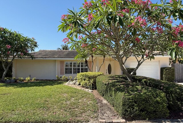 1807 Crafton Rd, North Palm Beach, FL 33408 - ranch-style house featuring stucco siding, a front yard, a garage, and a tile roof