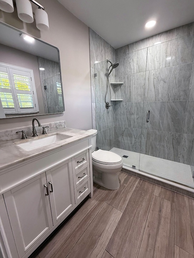 1807 Crafton Rd, North Palm Beach, FL 33408 - full bathroom featuring a shower stall, wood finished floors, vanity, toilet, and recessed lighting