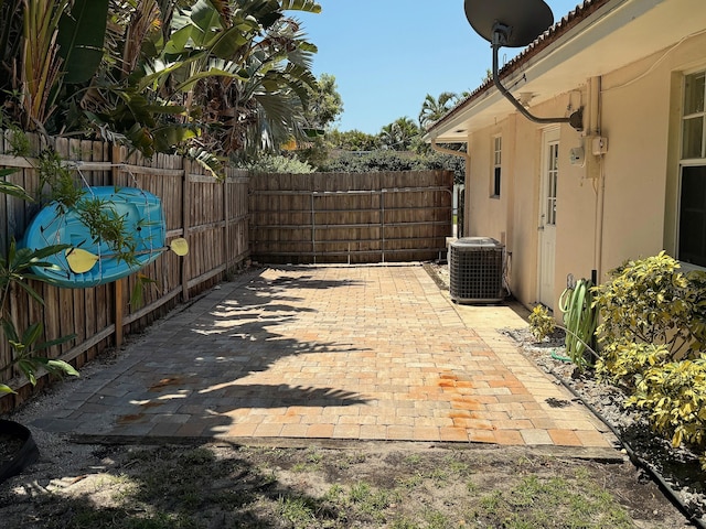 1807 Crafton Rd, North Palm Beach, FL 33408 - view of patio featuring cooling unit and a fenced backyard