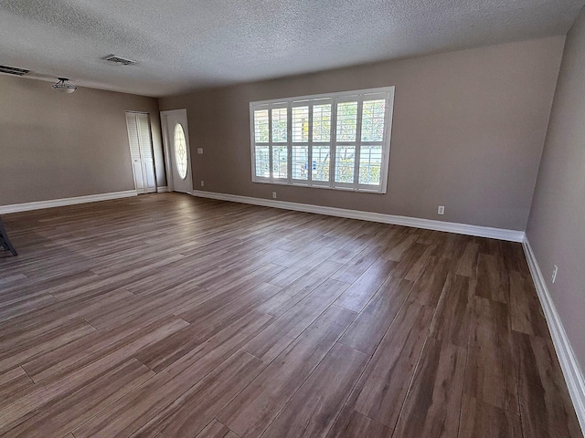 1807 Crafton Rd, North Palm Beach, FL 33408 - unfurnished room with a textured ceiling, dark wood-type flooring, and baseboards