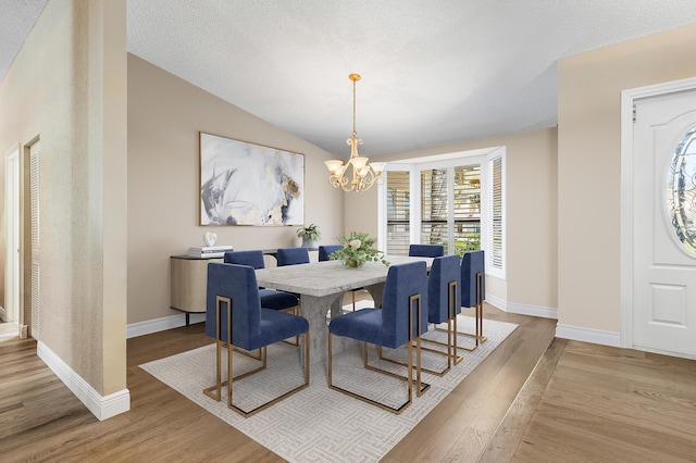 11700 Island Lakes Ln, Boca Raton, FL 33498 - dining area with wood finished floors, baseboards, a chandelier, and vaulted ceiling