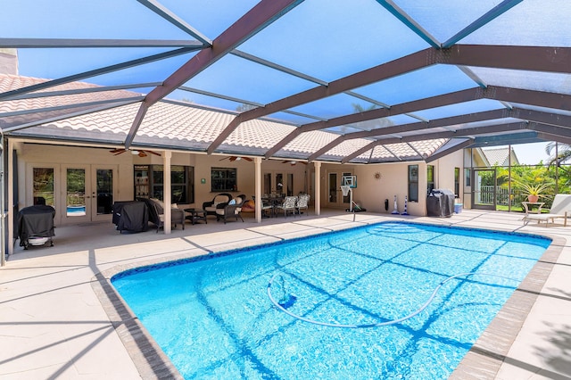 11700 Island Lakes Ln, Boca Raton, FL 33498 - outdoor pool with french doors, ceiling fan, a patio area, and a lanai