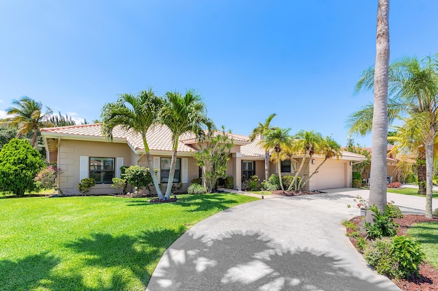 11700 Island Lakes Ln, Boca Raton, FL 33498 - view of front facade featuring an attached garage, a tile roof, concrete driveway, and a front lawn