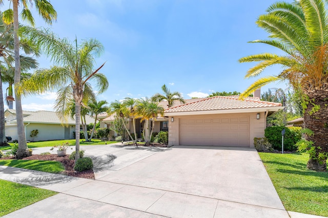 11700 Island Lakes Ln, Boca Raton, FL 33498 - view of front of house with a tile roof, concrete driveway, stucco siding, a garage, and a front yard