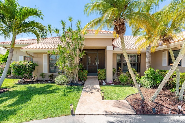 11700 Island Lakes Ln, Boca Raton, FL 33498 - mediterranean / spanish house with a tiled roof, stucco siding, and a front yard