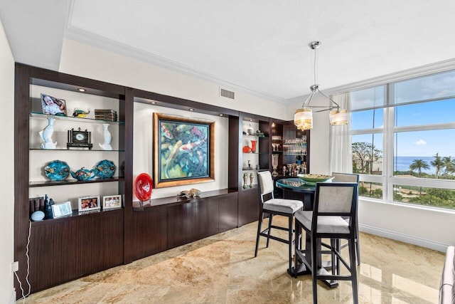 3740 S Ocean Blvd Unit 403, Highland Beach, FL 33487 - dining area with crown molding and a chandelier