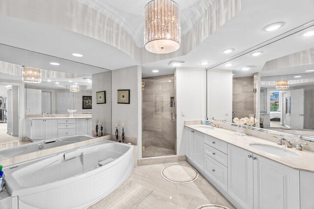 3740 S Ocean Blvd Unit 403, Highland Beach, FL 33487 - bathroom featuring a stall shower, a chandelier, a garden tub, double vanity, and recessed lighting