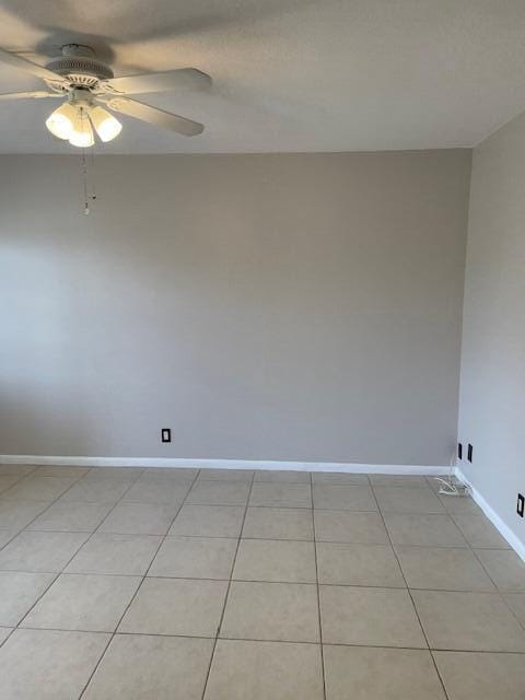 111 SE 1st St Unit 7, Boynton Beach, FL 33435 - empty room featuring baseboards, a ceiling fan, and light tile patterned floors