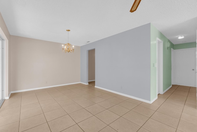 10109 45th Trl S, Boynton Beach, FL 33436 - spare room with a chandelier, light tile patterned floors, and baseboards