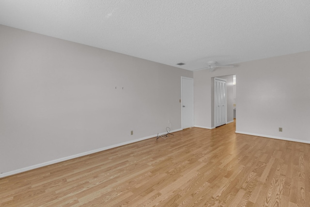 10109 45th Trl S, Boynton Beach, FL 33436 - unfurnished room with light wood-type flooring, baseboards, a textured ceiling, and a ceiling fan