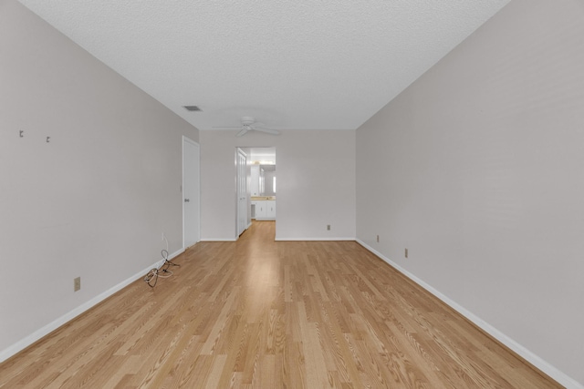 10109 45th Trl S, Boynton Beach, FL 33436 - empty room with light wood finished floors, baseboards, a ceiling fan, and a textured ceiling