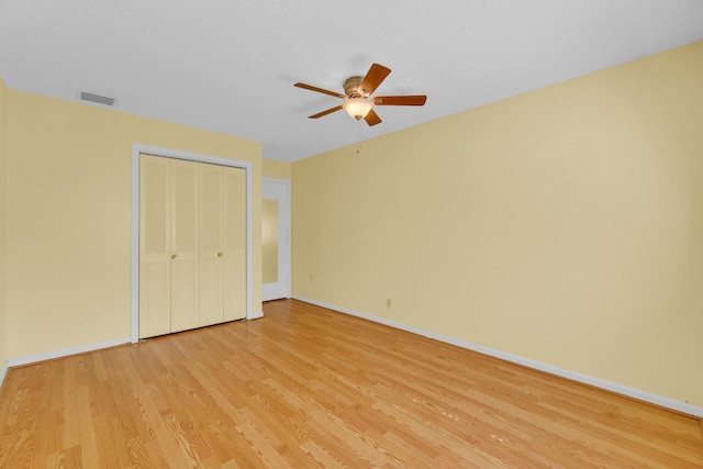 10109 45th Trl S, Boynton Beach, FL 33436 - unfurnished bedroom with light wood-style flooring, baseboards, a closet, and a ceiling fan