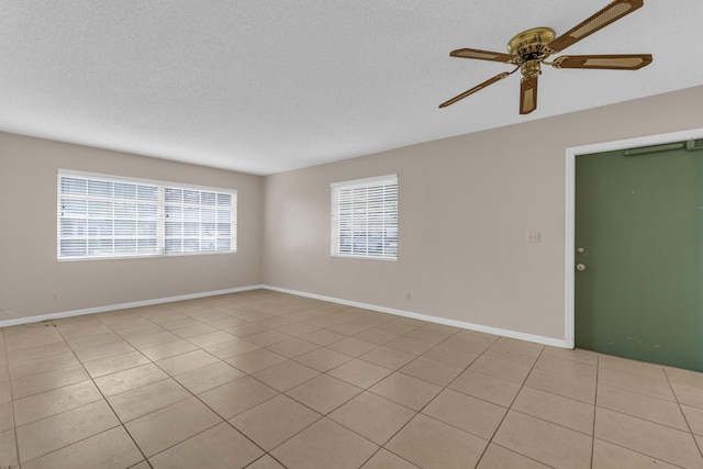 10109 45th Trl S, Boynton Beach, FL 33436 - empty room featuring a ceiling fan, light tile patterned flooring, baseboards, and a textured ceiling