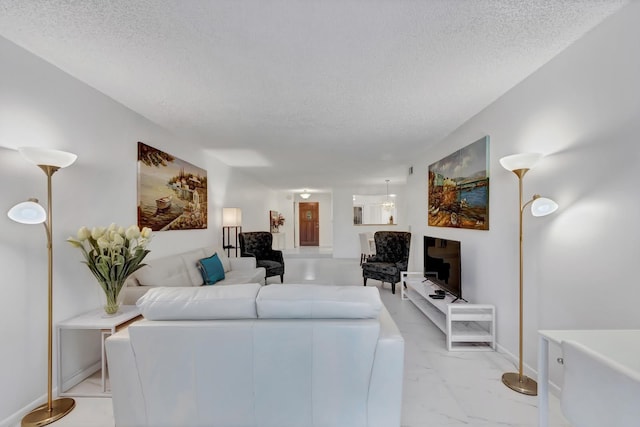 7844 La Mirada Dr, Boca Raton, FL 33433 - living area with a textured ceiling, light marble finish floors, and baseboards