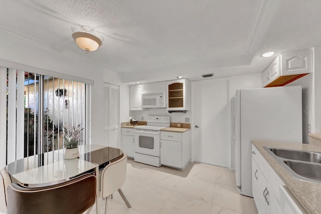 7844 La Mirada Dr, Boca Raton, FL 33433 - kitchen with white appliances, light marble finish flooring, a sink, white cabinetry, and light countertops