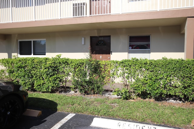 7955 NW 5th Ct Unit 103, Margate, FL 33063 - doorway to property with stucco siding and uncovered parking