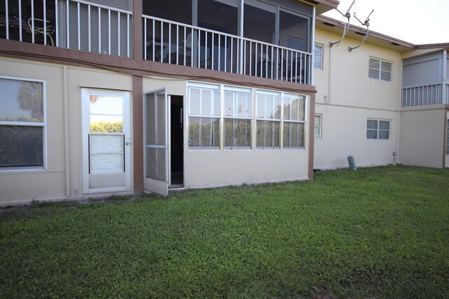 7955 NW 5th Ct Unit 103, Margate, FL 33063 - rear view of house featuring stucco siding and a lawn