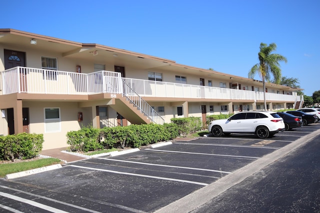 7955 NW 5th Ct Unit 103, Margate, FL 33063 - view of property with uncovered parking and stairs