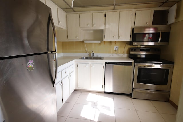 7955 NW 5th Ct Unit 103, Margate, FL 33063 - kitchen with stainless steel appliances, a sink, light countertops, light tile patterned flooring, and decorative backsplash