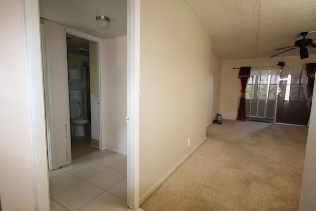 7955 NW 5th Ct Unit 103, Margate, FL 33063 - hallway featuring a textured ceiling, light colored carpet, and baseboards