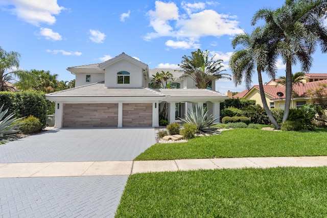 2646 NW 49th St, Boca Raton, FL 33434 - view of front of home featuring an attached garage, decorative driveway, stucco siding, a front lawn, and a tiled roof