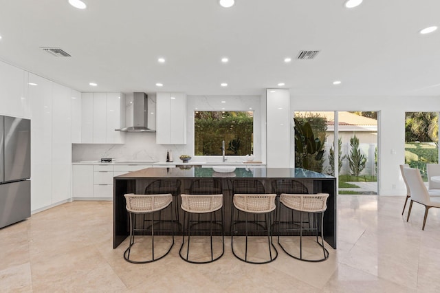 2646 NW 49th St, Boca Raton, FL 33434 - kitchen featuring modern cabinets, wall chimney range hood, freestanding refrigerator, white cabinetry, and a large island