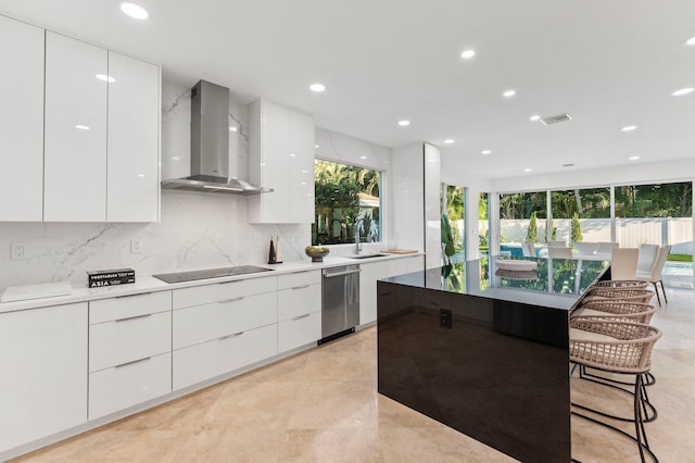 2646 NW 49th St, Boca Raton, FL 33434 - kitchen featuring modern cabinets, wall chimney range hood, stainless steel dishwasher, black electric stovetop, and white cabinets
