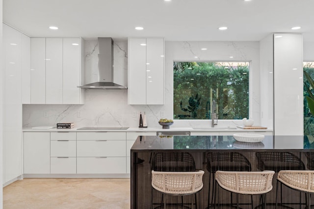 2646 NW 49th St, Boca Raton, FL 33434 - kitchen with modern cabinets, wall chimney range hood, white cabinetry, and recessed lighting