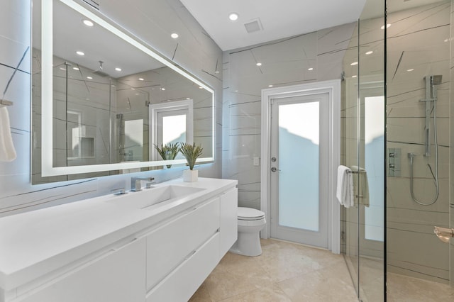 2646 NW 49th St, Boca Raton, FL 33434 - bathroom featuring a stall shower, toilet, vanity, tile patterned floors, and tile walls