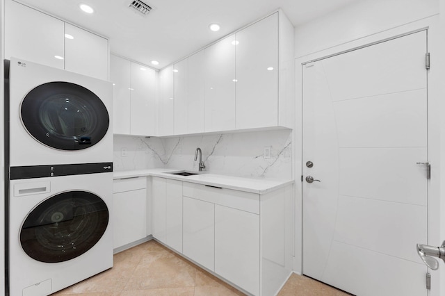 2646 NW 49th St, Boca Raton, FL 33434 - washroom featuring stacked washer and clothes dryer, cabinet space, recessed lighting, and light tile patterned floors