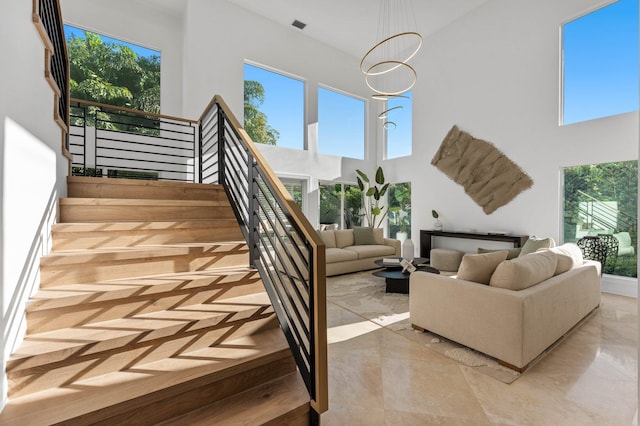 2646 NW 49th St, Boca Raton, FL 33434 - living area featuring a high ceiling, stairway, and a chandelier