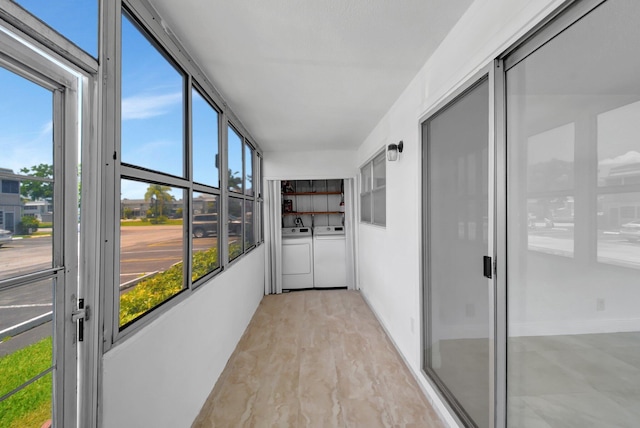 unfurnished sunroom featuring washer and dryer