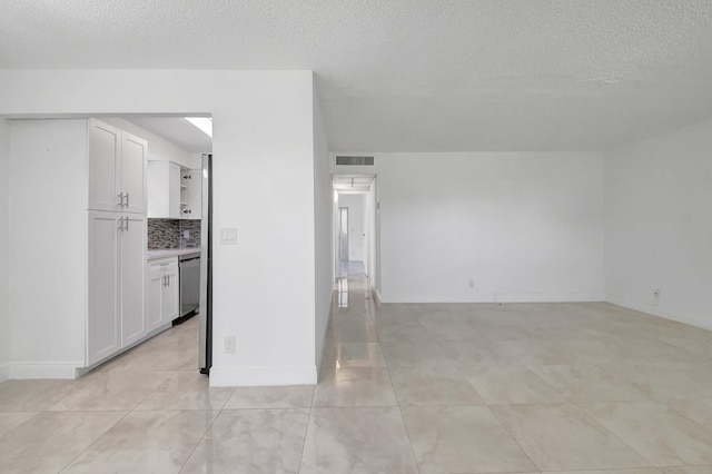 unfurnished room featuring a textured ceiling