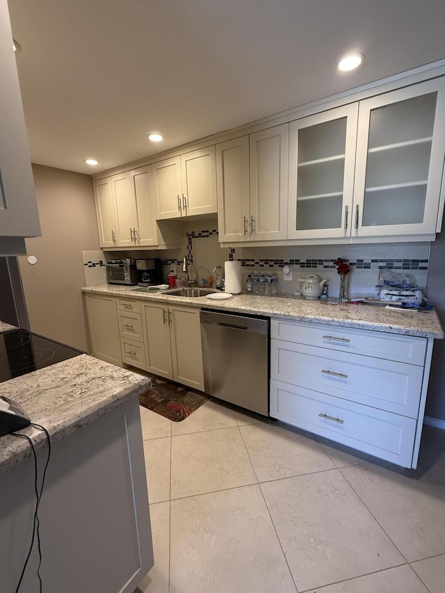 1008 Wolverton A, Boca Raton, FL 33434 - kitchen with stainless steel dishwasher, glass insert cabinets, tasteful backsplash, light tile patterned floors, and recessed lighting