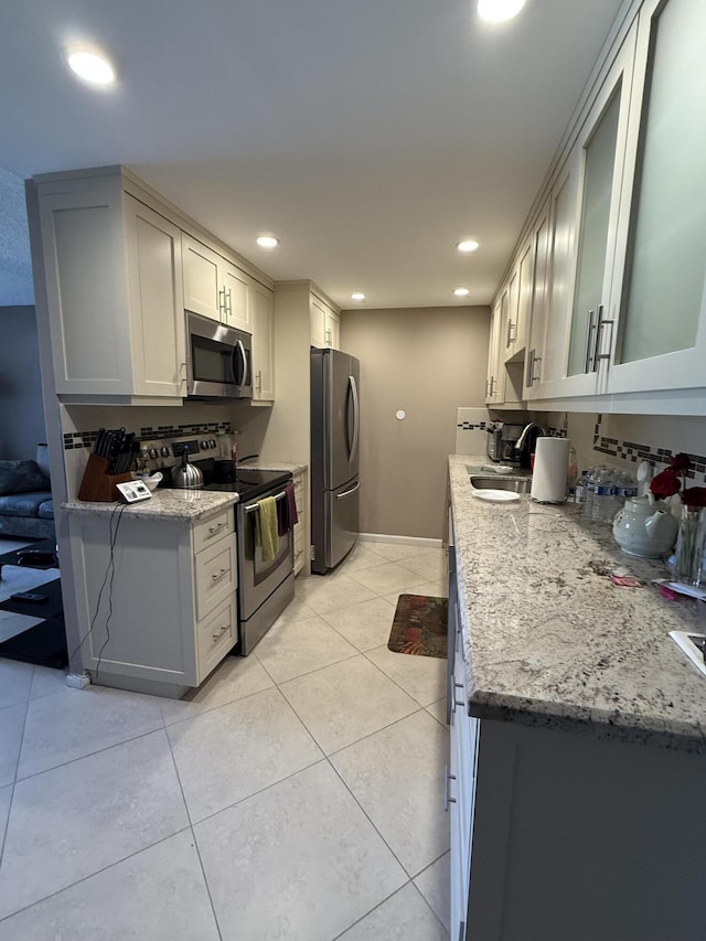 1008 Wolverton A, Boca Raton, FL 33434 - kitchen featuring appliances with stainless steel finishes, a sink, recessed lighting, and light tile patterned flooring