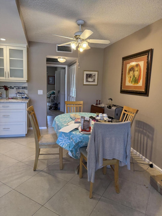 1008 Wolverton A, Boca Raton, FL 33434 - dining room featuring light tile patterned flooring, ceiling fan, a textured ceiling, and baseboards