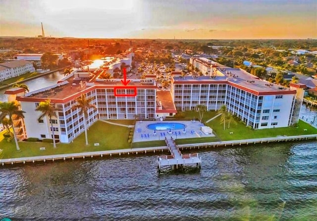 100 Paradise Harbour Blvd Unit 502, North Palm Beach, FL 33408 - aerial view at dusk of a water view and a view of apartment building / complex