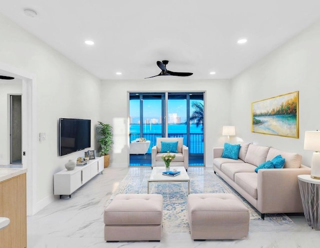 100 Paradise Harbour Blvd Unit 502, North Palm Beach, FL 33408 - living area with marble look tile flooring, ceiling fan, baseboards, and recessed lighting