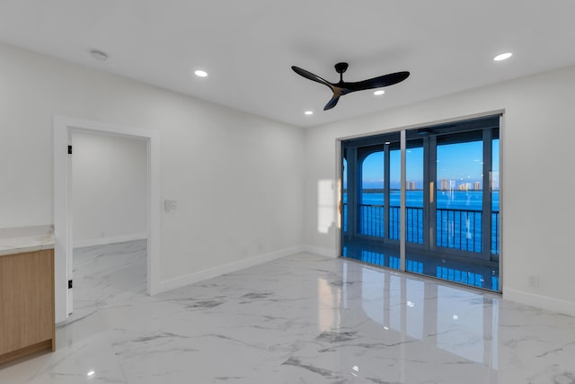 100 Paradise Harbour Blvd Unit 502, North Palm Beach, FL 33408 - spare room featuring marble finish floors, a ceiling fan, a smoke detector, baseboards, and recessed lighting