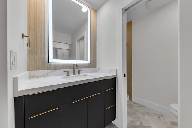 100 Paradise Harbour Blvd Unit 502, North Palm Beach, FL 33408 - bathroom featuring toilet, vanity, and baseboards