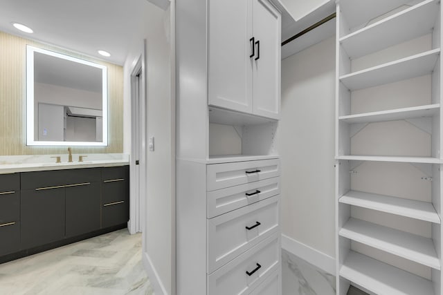 100 Paradise Harbour Blvd Unit 502, North Palm Beach, FL 33408 - walk in closet featuring a sink and light marble finish flooring