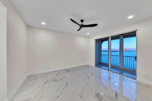 100 Paradise Harbour Blvd Unit 502, North Palm Beach, FL 33408 - unfurnished room featuring marble finish flooring, ceiling fan, baseboards, recessed lighting, and a water view