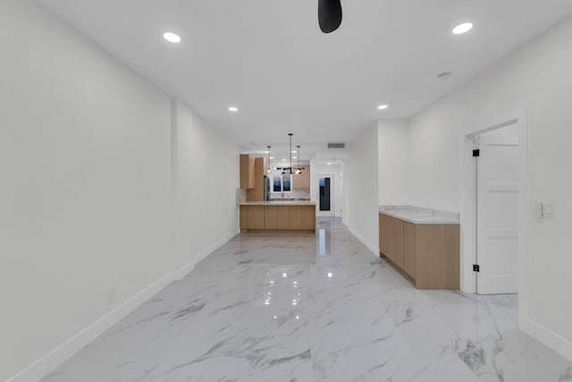 100 Paradise Harbour Blvd Unit 502, North Palm Beach, FL 33408 - unfurnished living room with baseboards, recessed lighting, and light marble finish floors