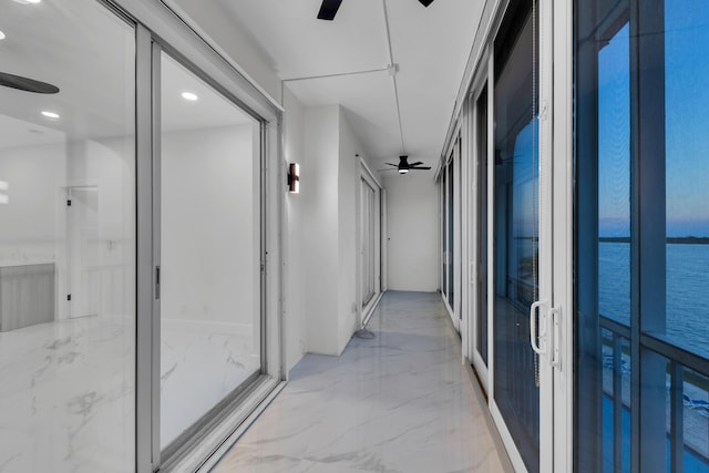 100 Paradise Harbour Blvd Unit 502, North Palm Beach, FL 33408 - hall with light marble finish flooring, a water view, and recessed lighting